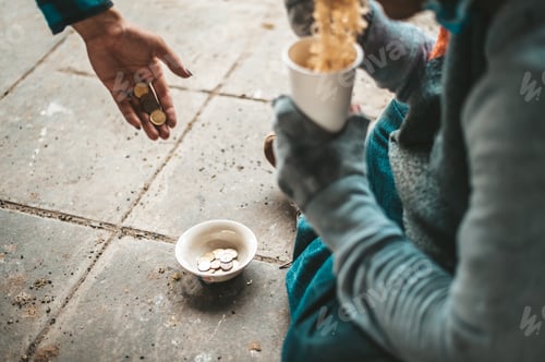 Preview: The beggars sat wrapped in cloths and eating noodles.