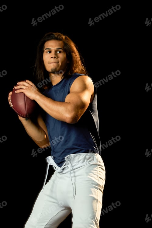 Preview: Portrait of football player with football, black background