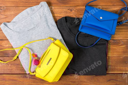 Preview: Brightly Colored T-Shirts and Purses Flat Lay