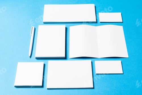 Preview: blank office objects organized for company presentation on blue paper background