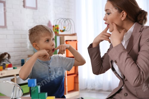 Preview: Speech therapist working with little boy in office