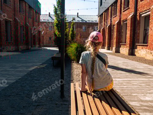 Preview: Child girl rests in modern cafe in loft style Break-out area red brick walls Old building renovation