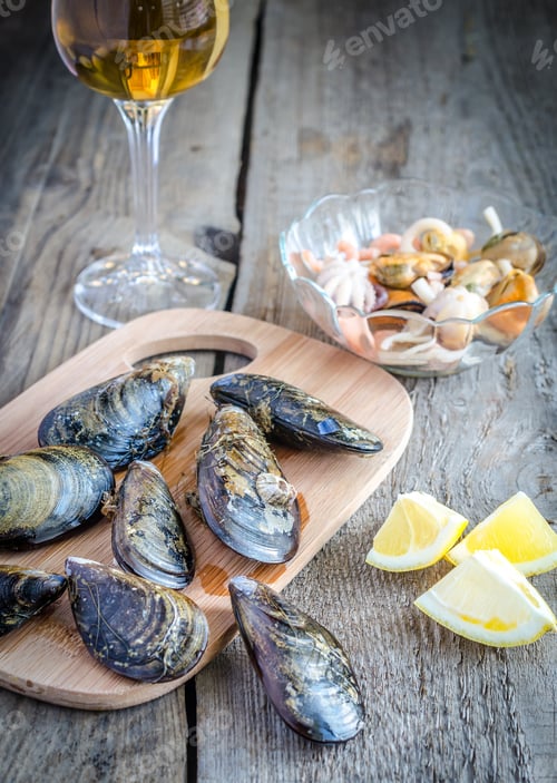 Preview: Mussels with a glass of white wine on the wooden table
