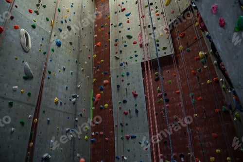 Preview: Ropes hanging by climbing wall in gym