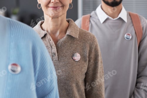 Preview: Mature smiling female voter with USA flag badge on chest