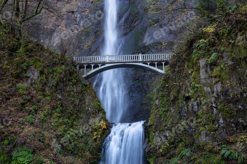 Preview: View of a bridge going over a river with Multnomah Falls in the background