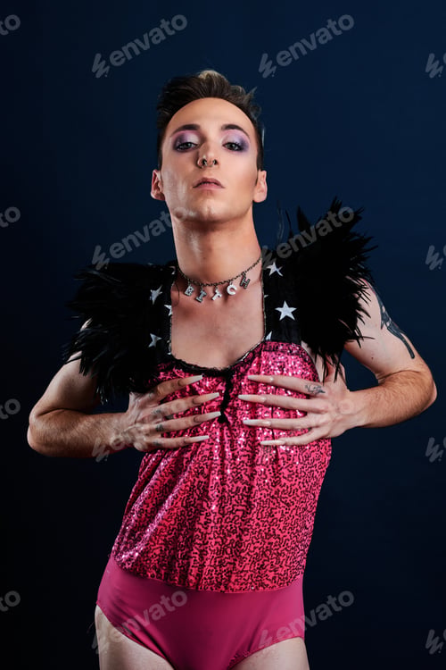Preview: young transgender model with pink dress and dark blue background