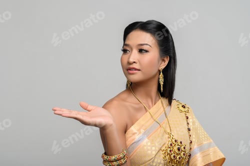 Preview: woman wearing Thai dress that made a hand symbol