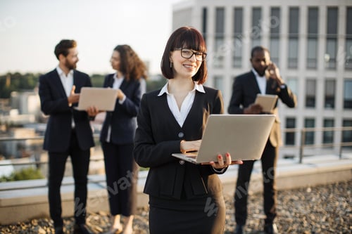 Preview: Diverse agents having business meeting on panoramic terrace