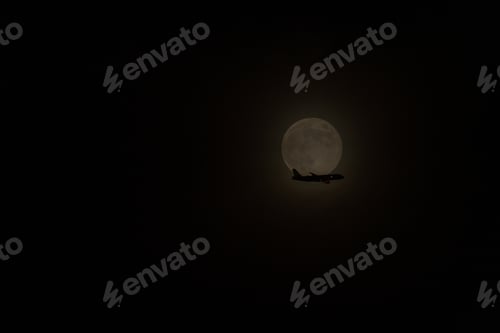 Preview: The passengers airplane flies in front of the full moon.