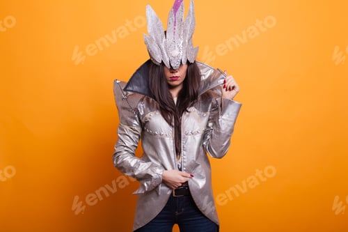 Preview: Young woman dressed in spooky halloween costume over yellow background