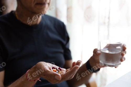 Preview: Man about to take his daily vitamins/ and tablets
