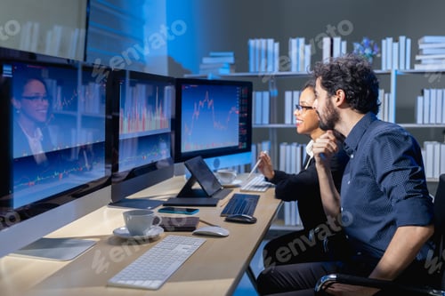 Preview: team brokers look at stock market graph on monitor compute