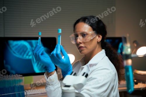 Preview: Scientist analyzing test tube liquid for medical research