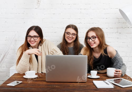 Preview: Portrait Of Three Laughing Girlfriends With Laptop. Young Girls Friends Happy Together With