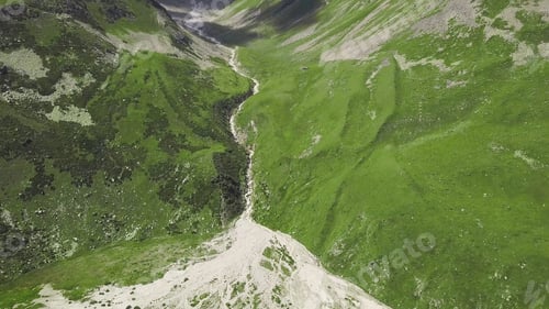 Preview: Top view on line of melt water in mountainous landscapes. Clip. Large fork in mountain bed from