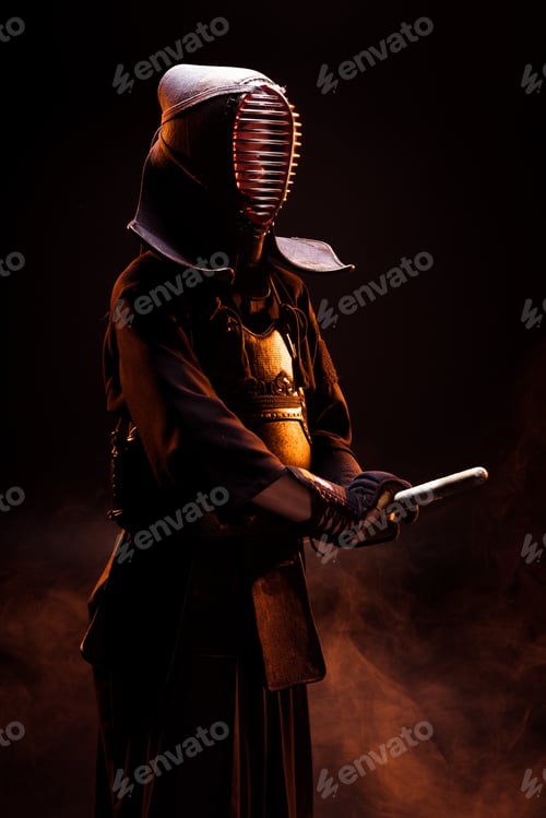 Preview: Kendo fighter in armor holding with bamboo sword on black