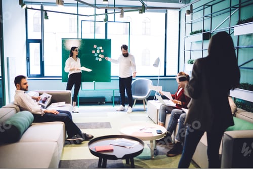 Preview: Work partners having conversation in hall of workplace
