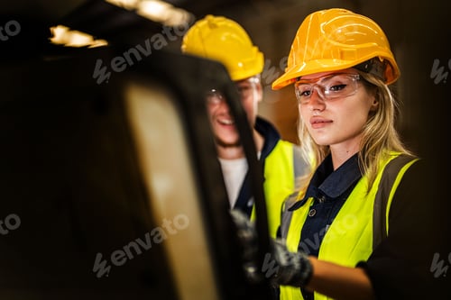 Preview: Factory engineer woman standing confidence to control panel switch