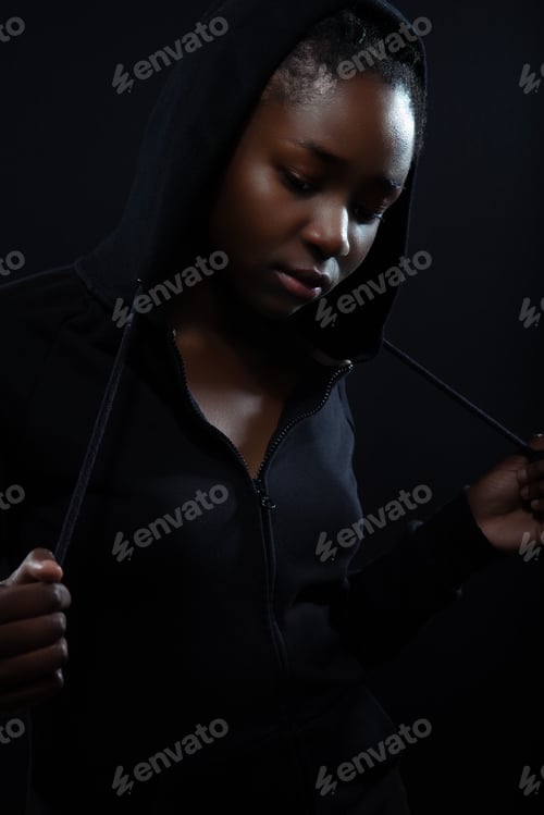 Preview: Cool and pensive woman with dark skin and attitude wearing hoodie