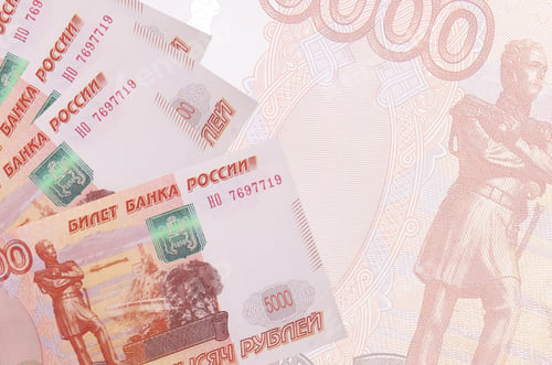 Preview: 5000 russian rubles bills lies in stack on background of big semi-transparent banknote. Abstract bu