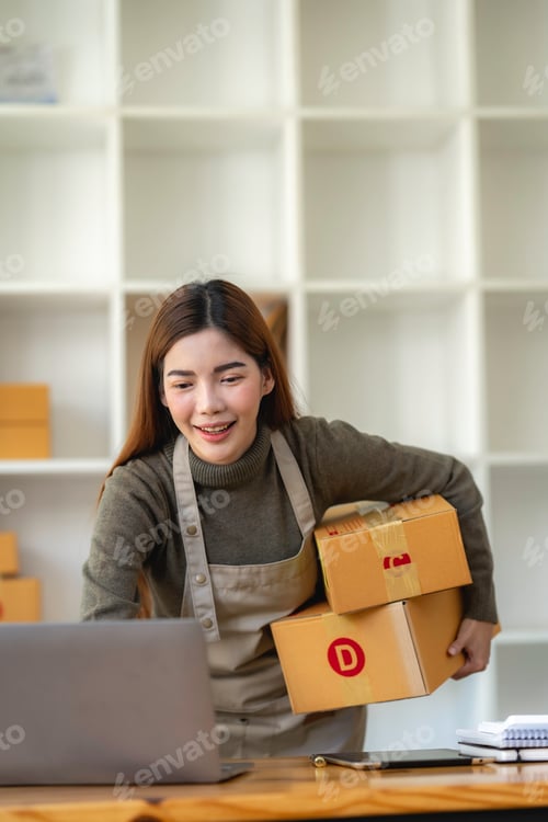 Preview: Asian Small business entrepreneur SME working with box and Surprised to look at the notebook screen