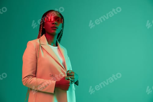 Preview: African american woman smile and fashion wearing glasses green background in neon light color mixed