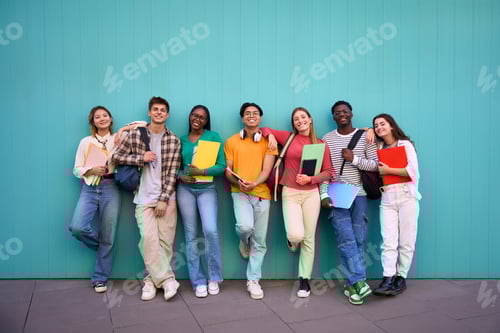 Preview: Smiling Students Standing Together Against a Turquoise Wall