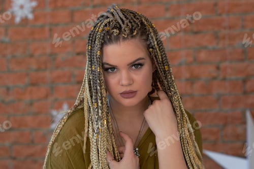 Preview: Beauty fashion portrait. Smiling young woman on Brick wall background.