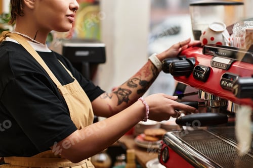 Preview: Young woman preparing coffee in a vibrant cafe filled with charm and personality