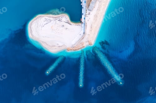 Preview: Aerial view of sandbank with breakwater at sunset in Greece