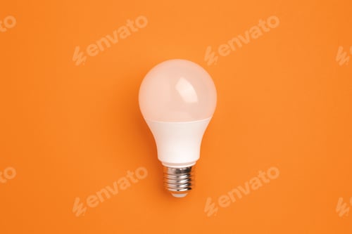Preview: LED lamp on a orange background. Energy saving concept, alternative energy sources, idea