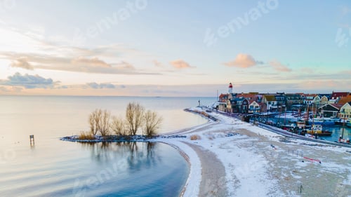 Preview: Lighthouse of Urk during winter with snow in the Netherlands