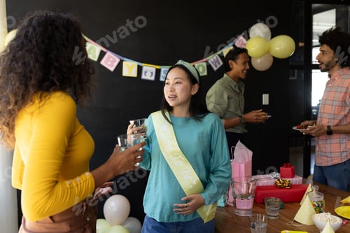 Preview: Expectant mother celebrating baby shower with friends, sharing conversation and laughter