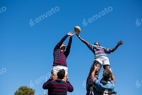Preview: Low angle view of teams playing rugby