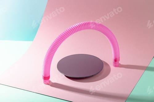 Preview: Mirror stand under pink antistress pop tube toy in shape of arch with shadow on pink background.