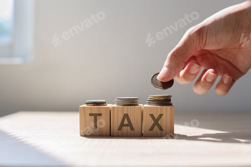 Preview: Hand put money coin above Tax word on wooden cubes.