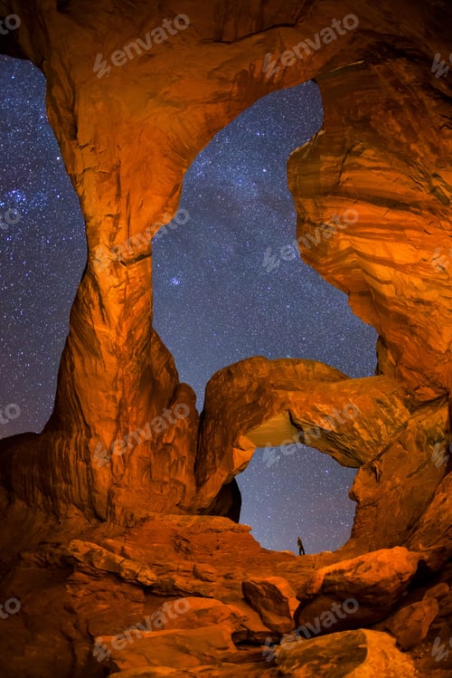 Preview: Hiker and night sky from Double Arch