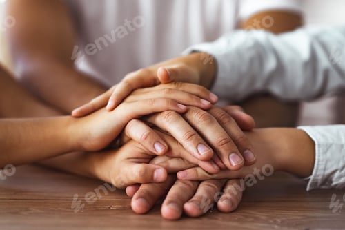 Preview: The family hold hands together at the table
