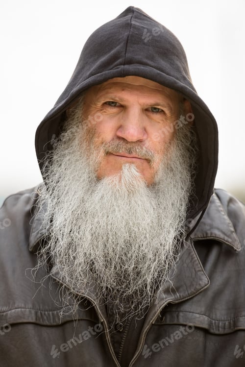 Preview: Face of mature bearded hipster man wearing hood