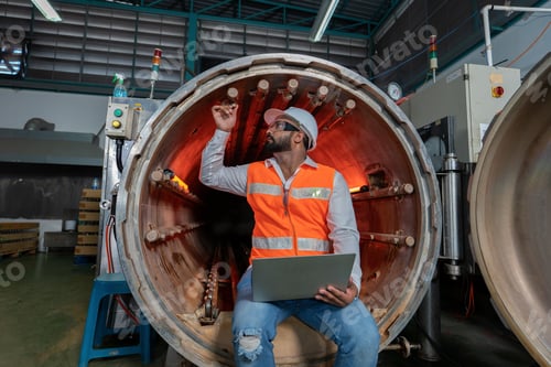 Preview: Engineer hold laptop tablet paper check list spray nozzle checking at pressure tank during shutdown