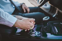 Preview: Closeup shot of a bride and groom holding hands in the car