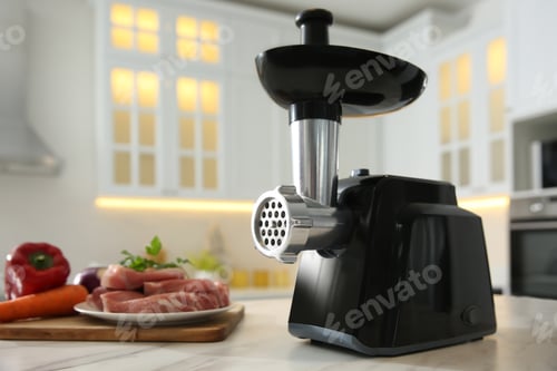 Preview: Modern meat grinder and products on white marble table in kitchen. Space for text
