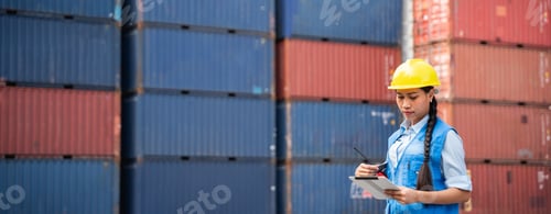 Preview: Engineer or foreman checking inventory or task details at container yard warehouse.