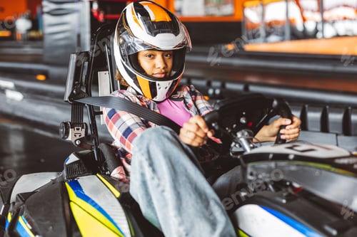 Preview: Young Woman Preparing for Go-Kart Race in Helmet