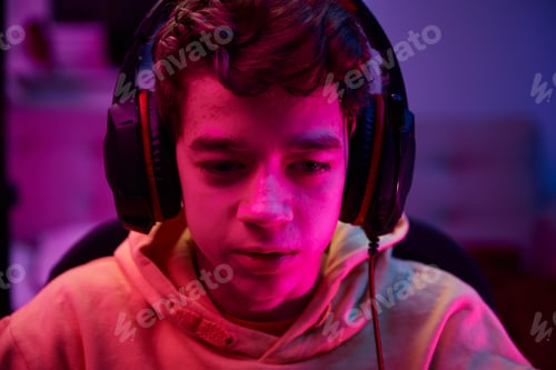 Preview: Boy plays computer game at home, gaming addiction