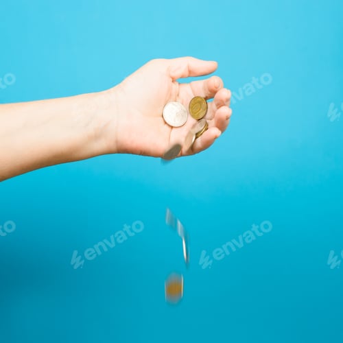 Preview: Elderly woman's hand and falling coins, blue background. Selective focus, motion blur. Income