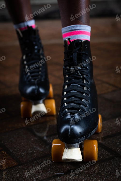Preview: Vertical shot of a woman in black roller skates on a floor
