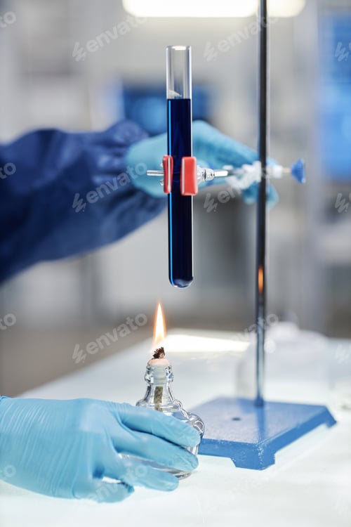 Preview: Scientist heating test tube over flame in laboratory