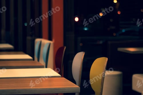 Preview: Colorful chairs and tables in a restaurant.